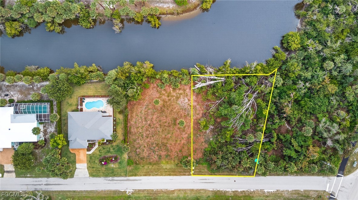 3304 St Kilda Road Sanibel, FL 33957 - Photo 14 of 23 an aerial view of a house with a yard and garden space