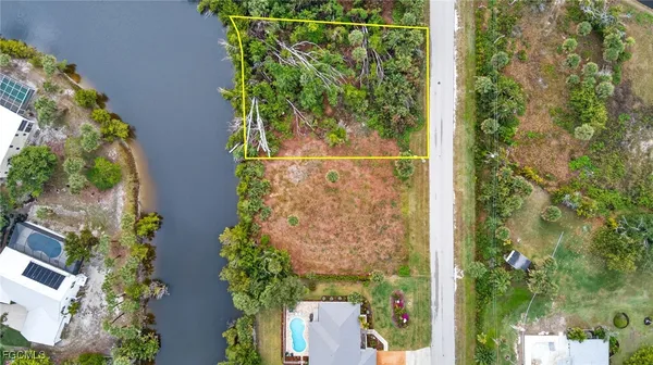 an aerial view of a residential houses with yard