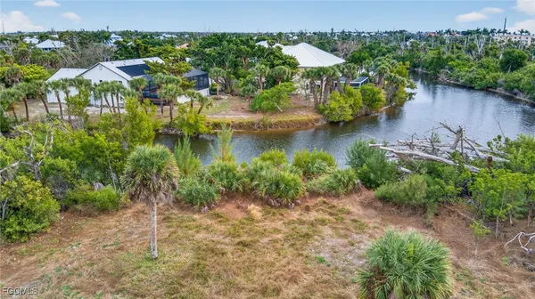 an aerial view of residential houses with outdoor space and lake view