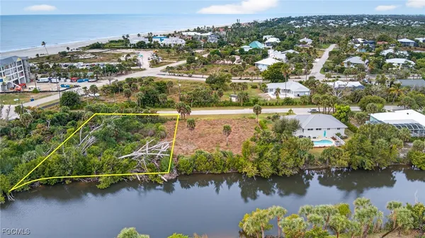 an aerial view of residential houses with outdoor space and lake view