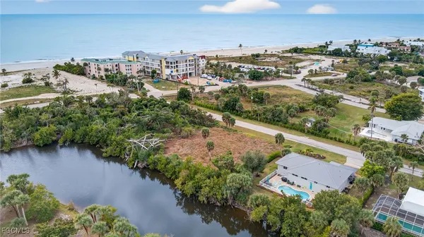 an aerial view of residential houses with outdoor space and trees