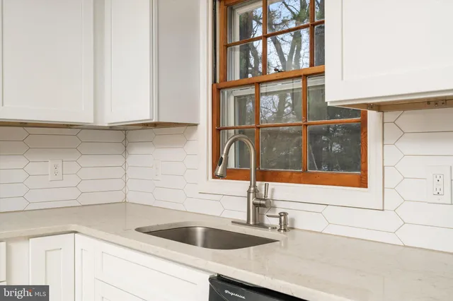 a kitchen with a sink and a window