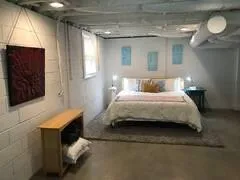 a bedroom with a bed and a night stand