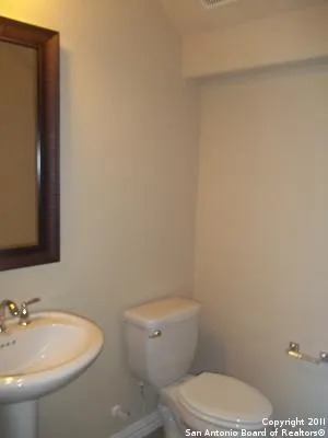 a white toilet sitting next to a bathroom sink