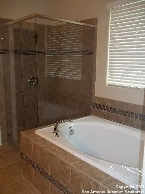 a bathroom with a bathtub and shower