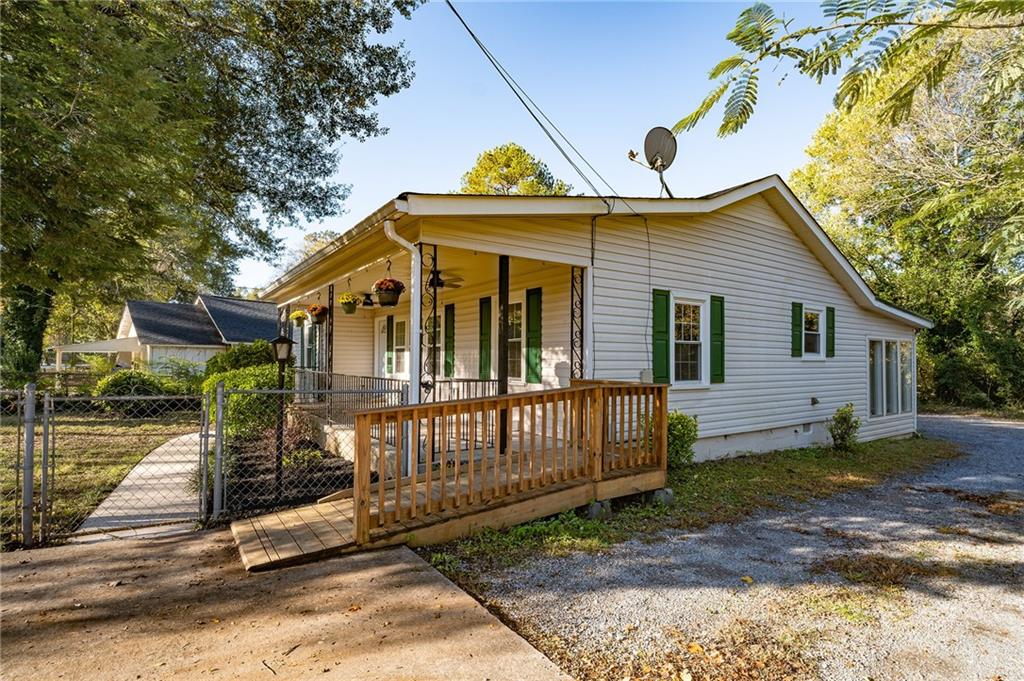 a view of a house with a small yard and wooden fence