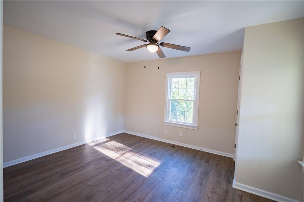 2710 Maple Road Southeast Rome, GA 30161 - Photo 16 of 20 a view of empty room with wooden floor and fan