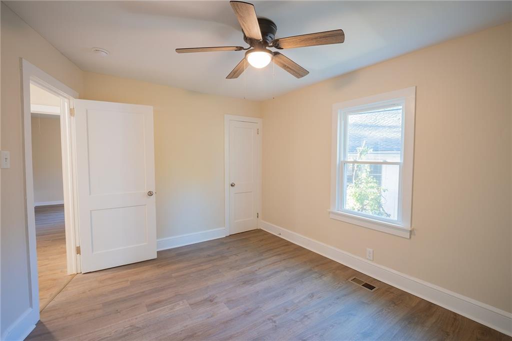 2710 Maple Road Southeast Rome, GA 30161 - Photo 17 of 20 wooden floor in an empty room with a window