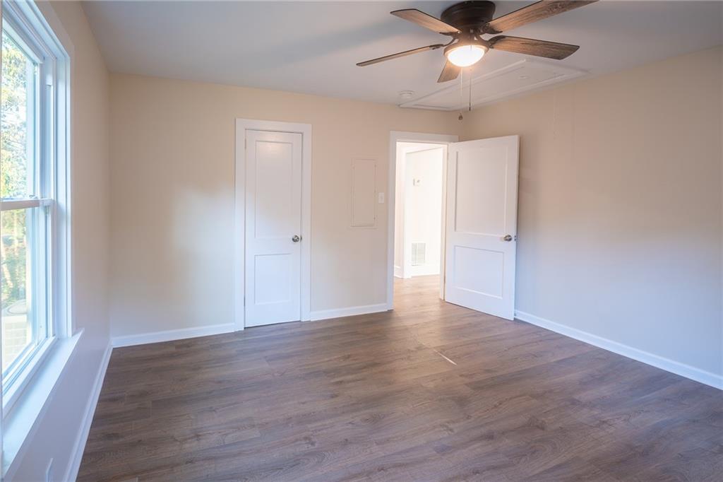 2710 Maple Road Southeast Rome, GA 30161 - Photo 18 of 20 a view of an empty room with wooden floor and a window
