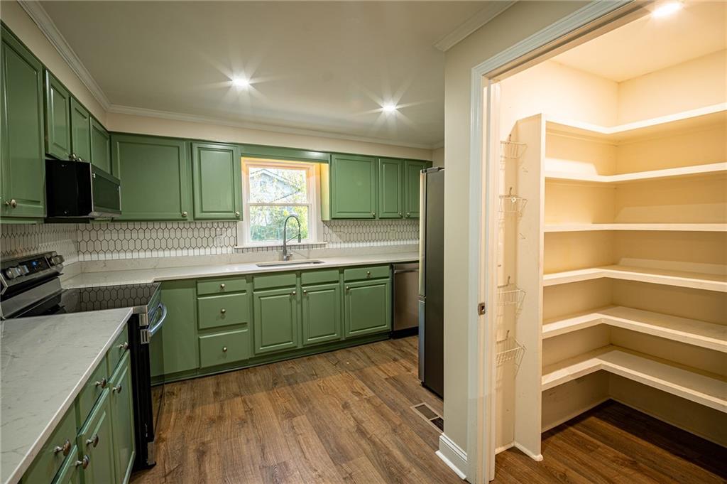 2710 Maple Road Southeast Rome, GA 30161 - Photo 9 of 20 a kitchen with a sink cabinets and wooden floor