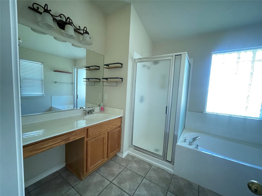 3508 Blue Ridge Drive Round Rock, TX 78681 - Photo 13 of 26 a bathroom with a tub sink shower and mirror