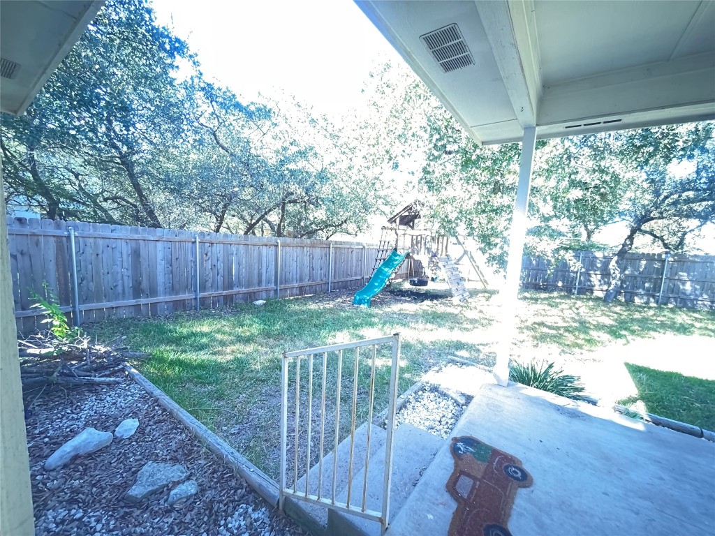 3508 Blue Ridge Drive Round Rock, TX 78681 - Photo 22 of 26 a view of a backyard with large trees and wooden fence