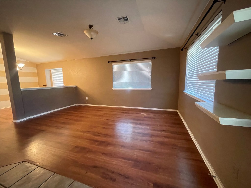 3508 Blue Ridge Drive Round Rock, TX 78681 - Photo 3 of 26 an empty room with wooden floor and windows