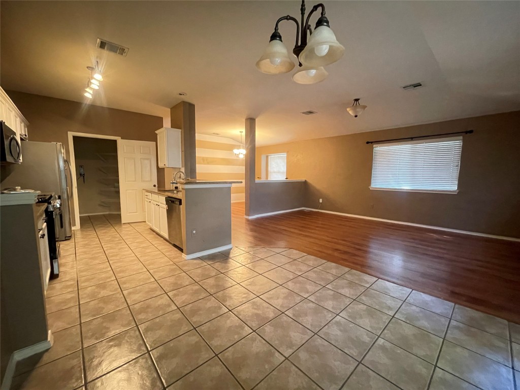 3508 Blue Ridge Drive Round Rock, TX 78681 - Photo 26 of 26 a view of a kitchen with a refrigerator and a stove top oven