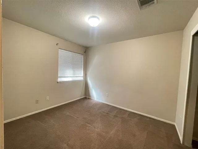 a view of a kitchen with a refrigerator and a stove top oven