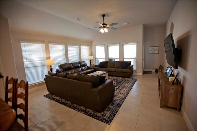 a living room with furniture and a flat screen tv