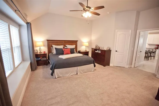 a bedroom with a large bed and a chandelier