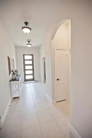 an empty room with windows and cabinet