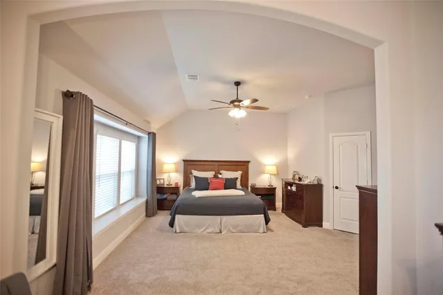 a living room with furniture and dining area