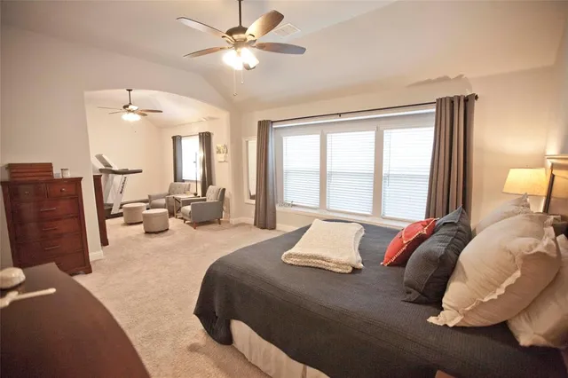 a bedroom with a bed dresser and a window