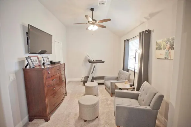 a living room with furniture and a mirror