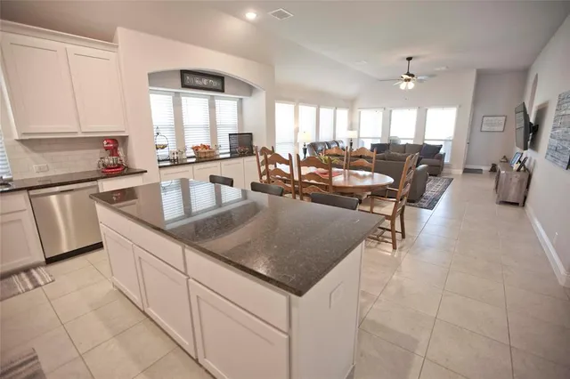 a kitchen with counter top space a sink cabinets and appliances