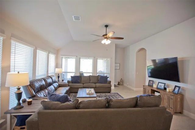 a living room with furniture and a flat screen tv
