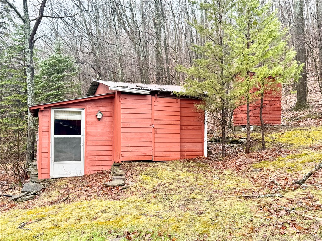 2595 Colby Creek Road Jasper, NY 14823 - Photo 25 of 37 Storage sheds to left. Outhouse to right.
