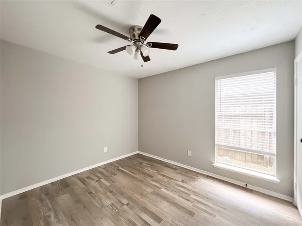 a view of a big room with wooden floor closet and windows