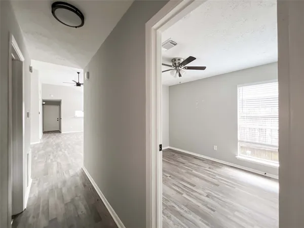 a view of room with window and wooden floor