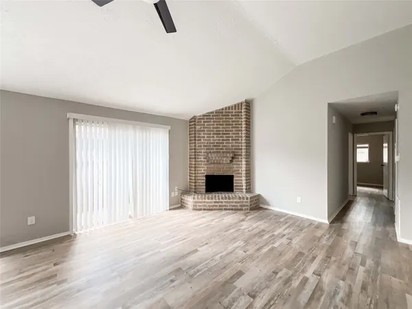 wooden floor fireplace and natural light in room