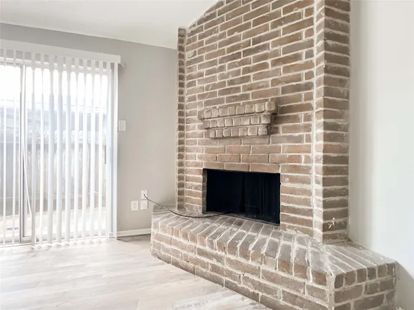 a bedroom with a bed and a fireplace