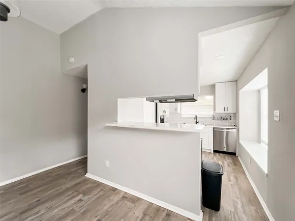 a kitchen with white cabinets and white appliances