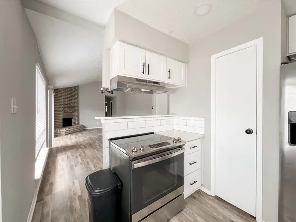 a kitchen with stainless steel appliances granite countertop a stove and a refrigerator