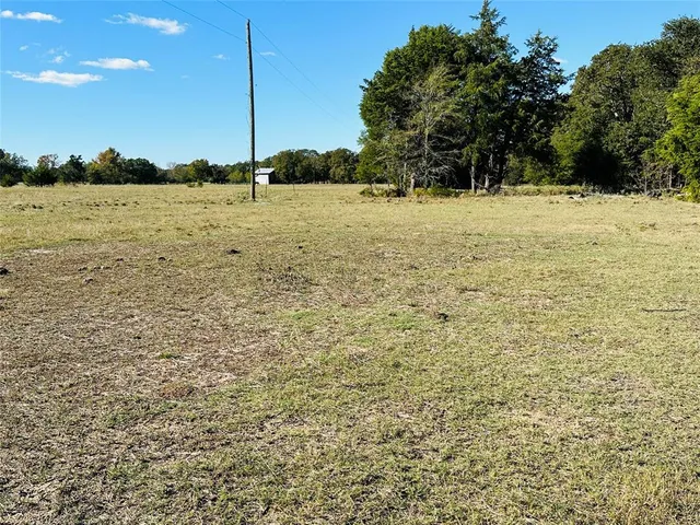 a view of a field with an outdoor space