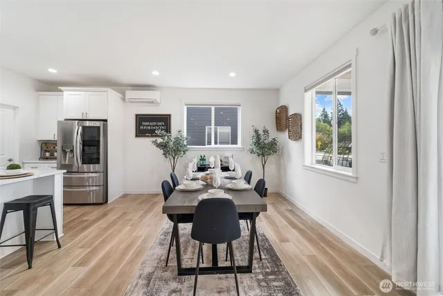 a view of a dining room with furniture window and wooden floor