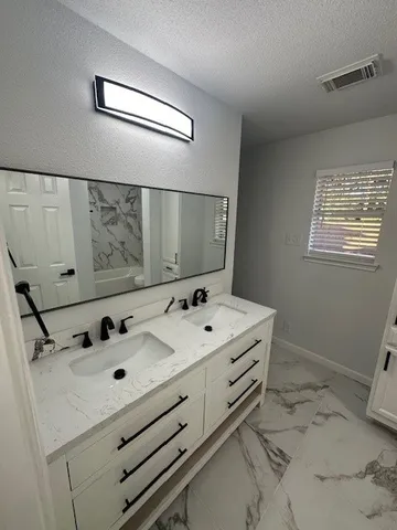 a bathroom with a sink and mirror