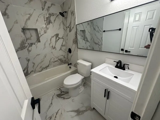 a bathroom with a sink a toilet and a bathtub