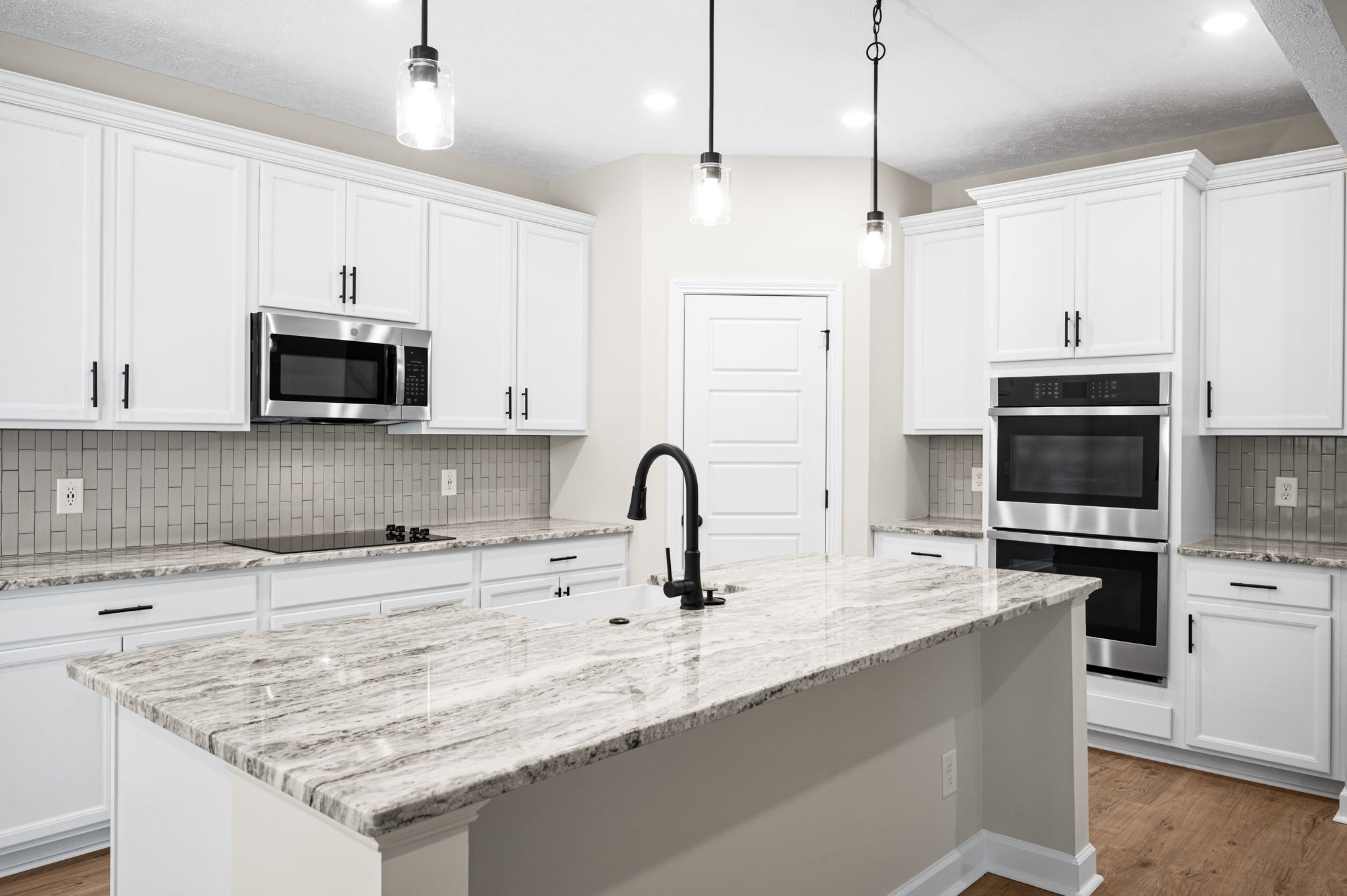 1749 Powell Road Clarksville, TN 37043 - Photo 11 of 50 a kitchen with granite countertop a sink stainless steel appliances and white cabinets