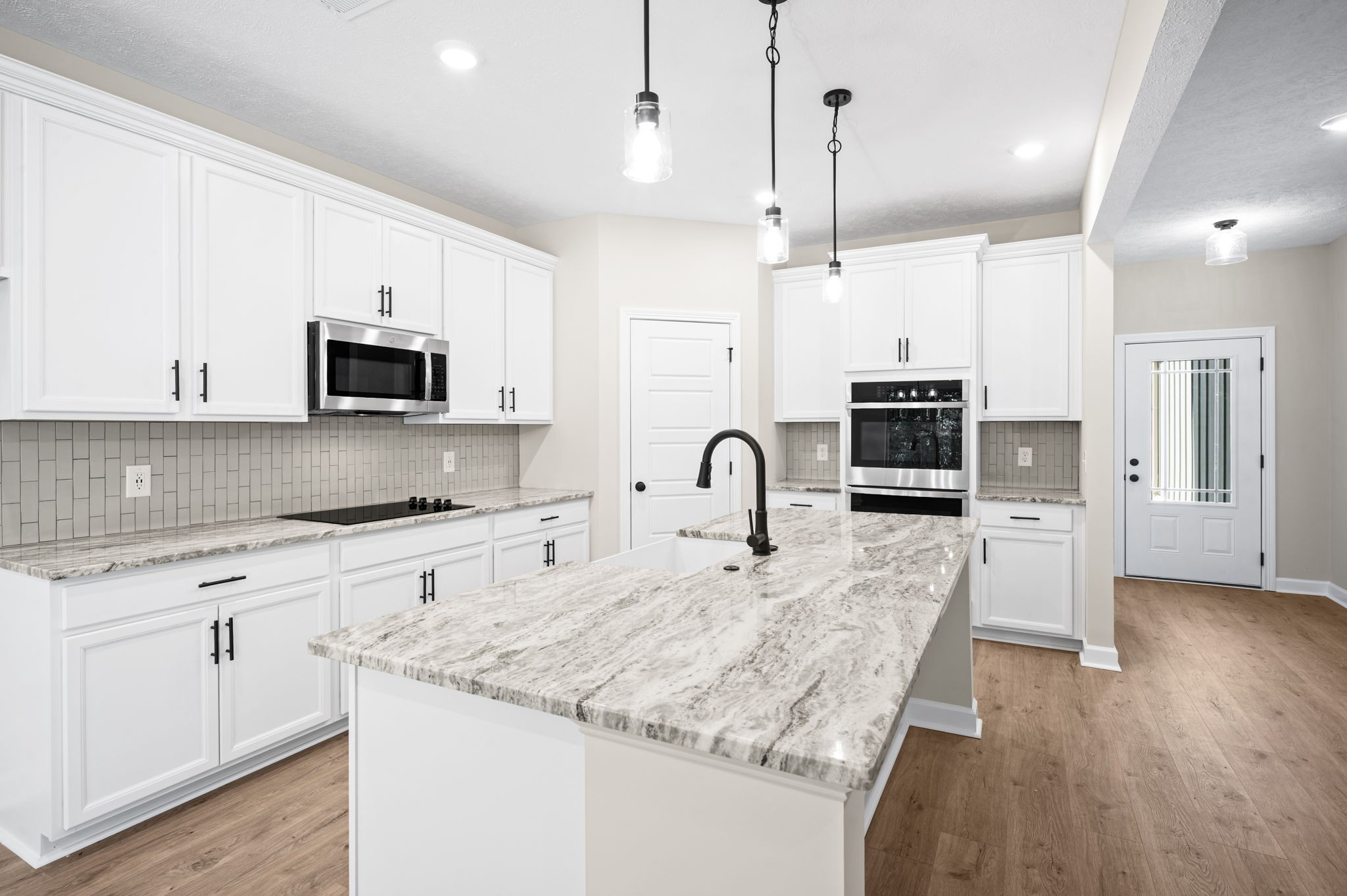 1749 Powell Road Clarksville, TN 37043 - Photo 2 of 50 a kitchen with stainless steel appliances granite countertop a stove top oven a refrigerator a sink and white cabinets with wooden floor