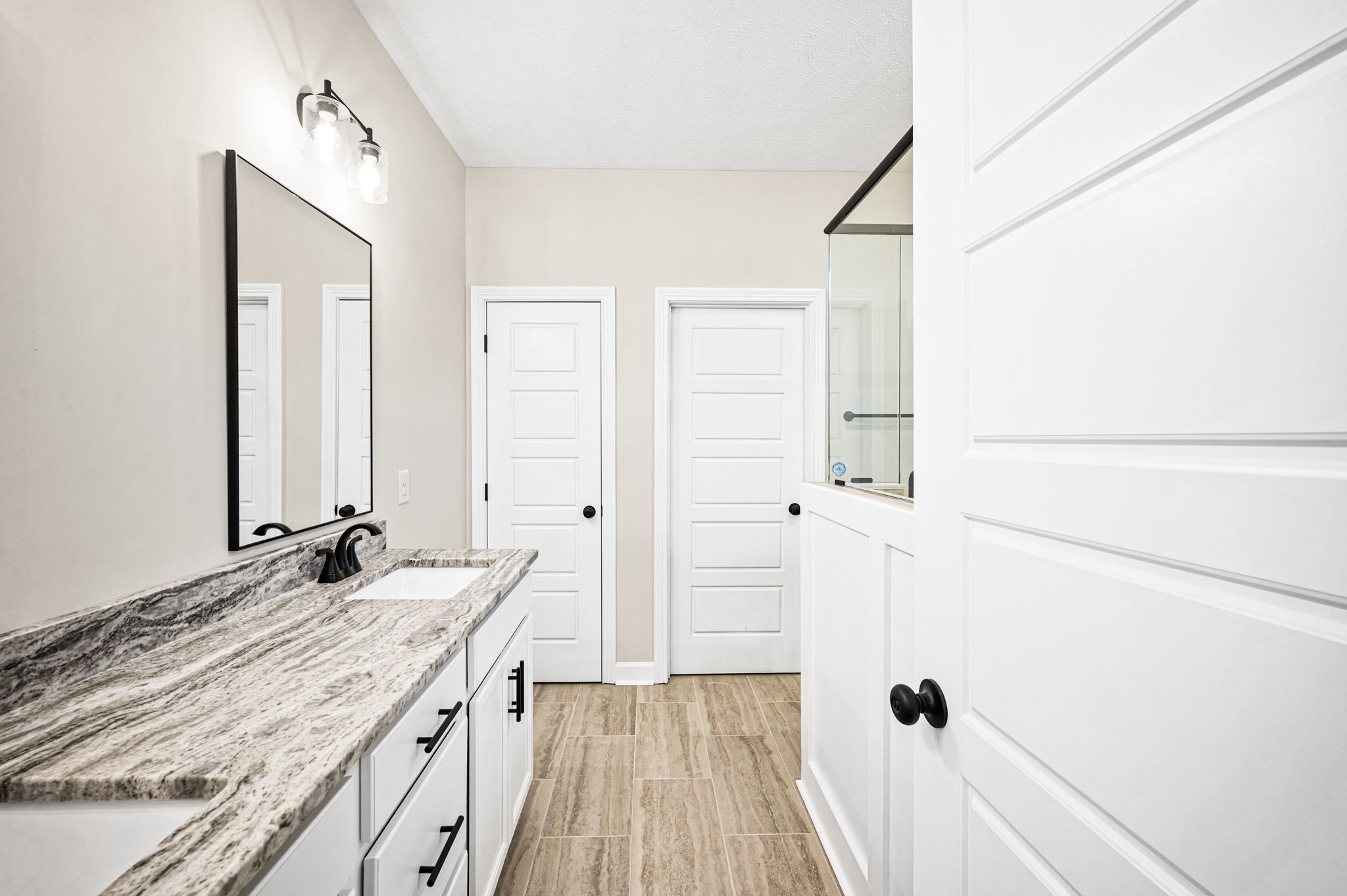 1749 Powell Road Clarksville, TN 37043 - Photo 24 of 50 a bathroom with a granite countertop sink and a mirror