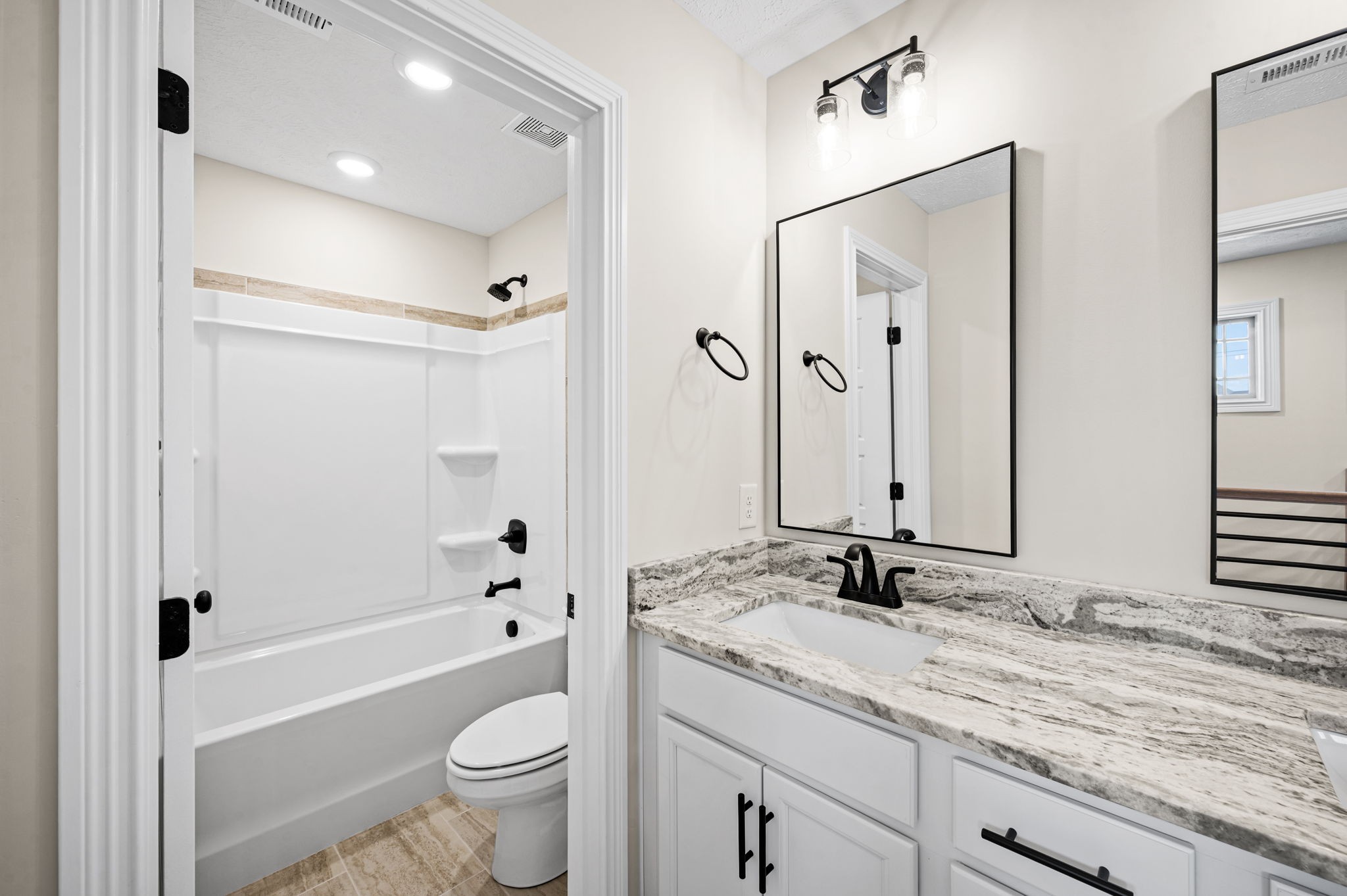 1749 Powell Road Clarksville, TN 37043 - Photo 38 of 50 a bathroom with a granite countertop sink toilet mirror and shower