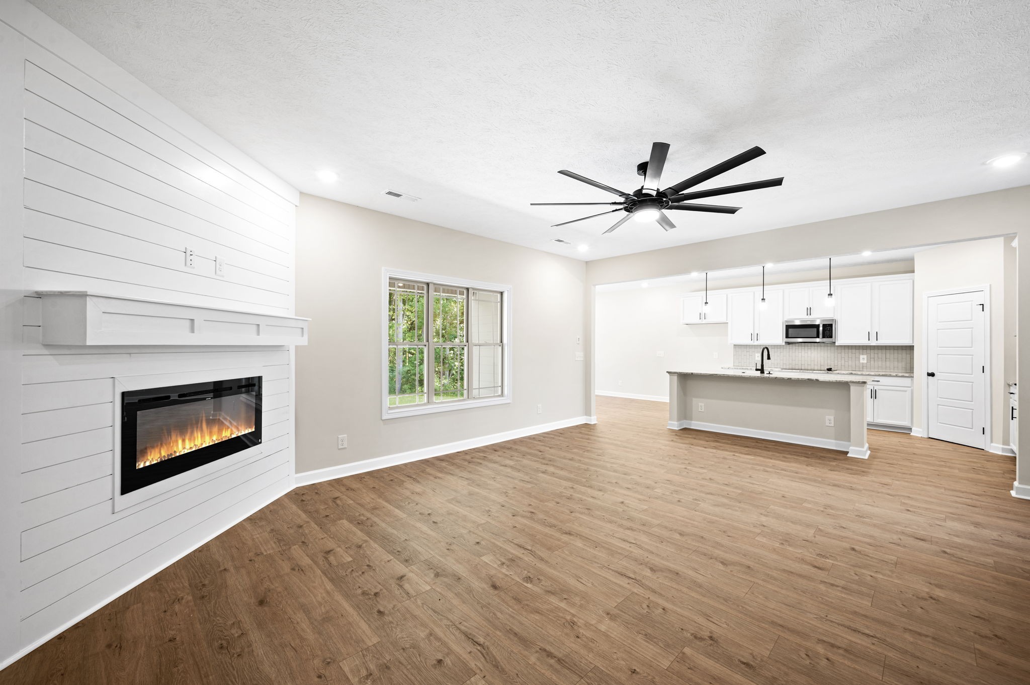 1749 Powell Road Clarksville, TN 37043 - Photo 7 of 50 a view of an empty room with a kitchen and a window
