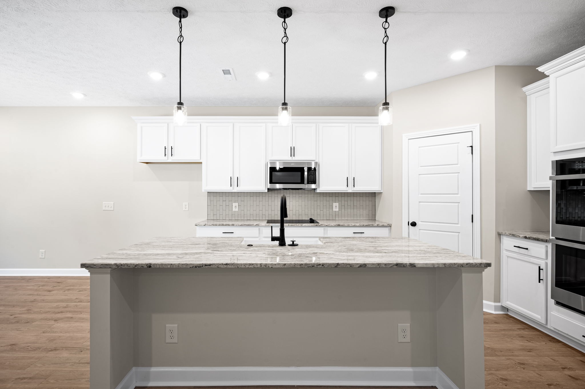 1749 Powell Road Clarksville, TN 37043 - Photo 10 of 50 a kitchen with kitchen island white cabinets stainless steel appliances and a center island