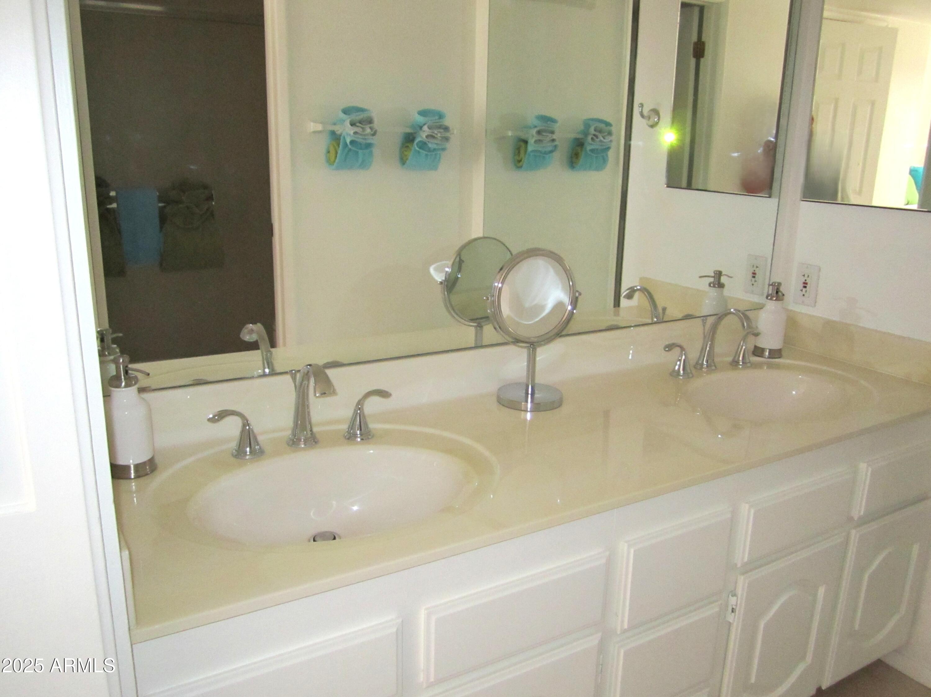 4303 East Cactus Road, Unit 413 Phoenix, AZ 85032 - Photo 15 of 30 a bathroom with double vanity sink and a mirror