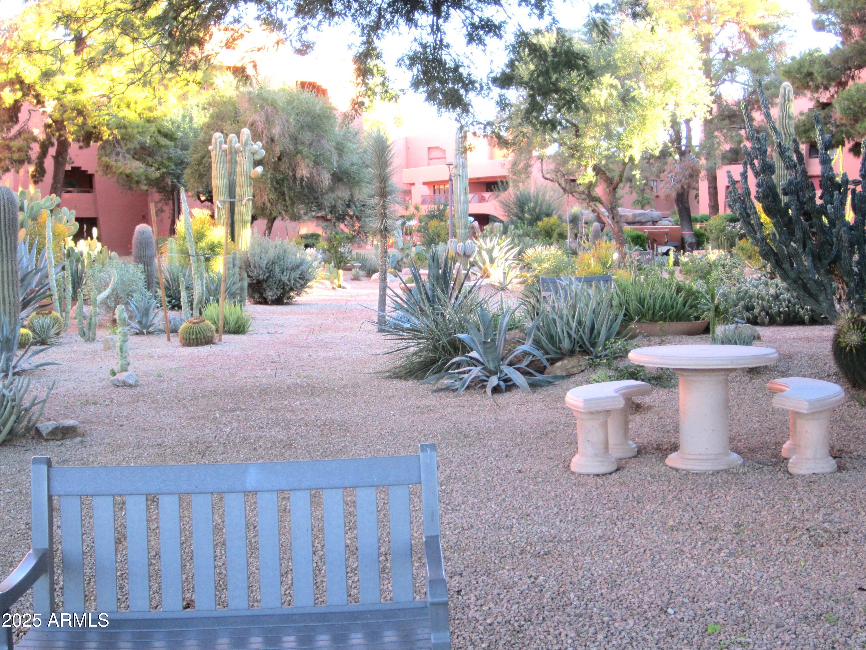 4303 East Cactus Road, Unit 413 Phoenix, AZ 85032 - Photo 26 of 30 a view of a patio with table and chairs and potted plants