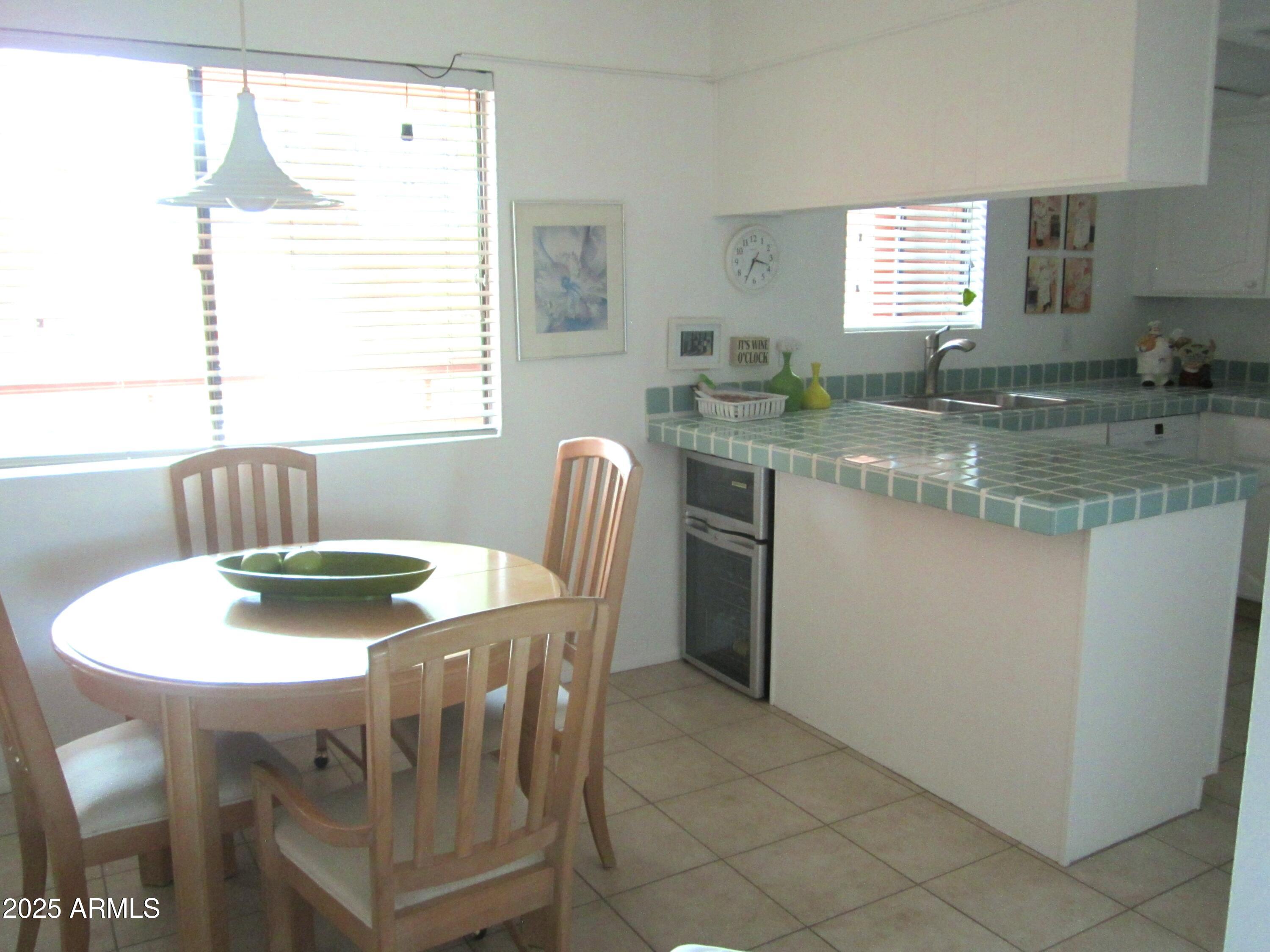 4303 East Cactus Road, Unit 413 Phoenix, AZ 85032 - Photo 3 of 30 a view of a dining room with furniture and window