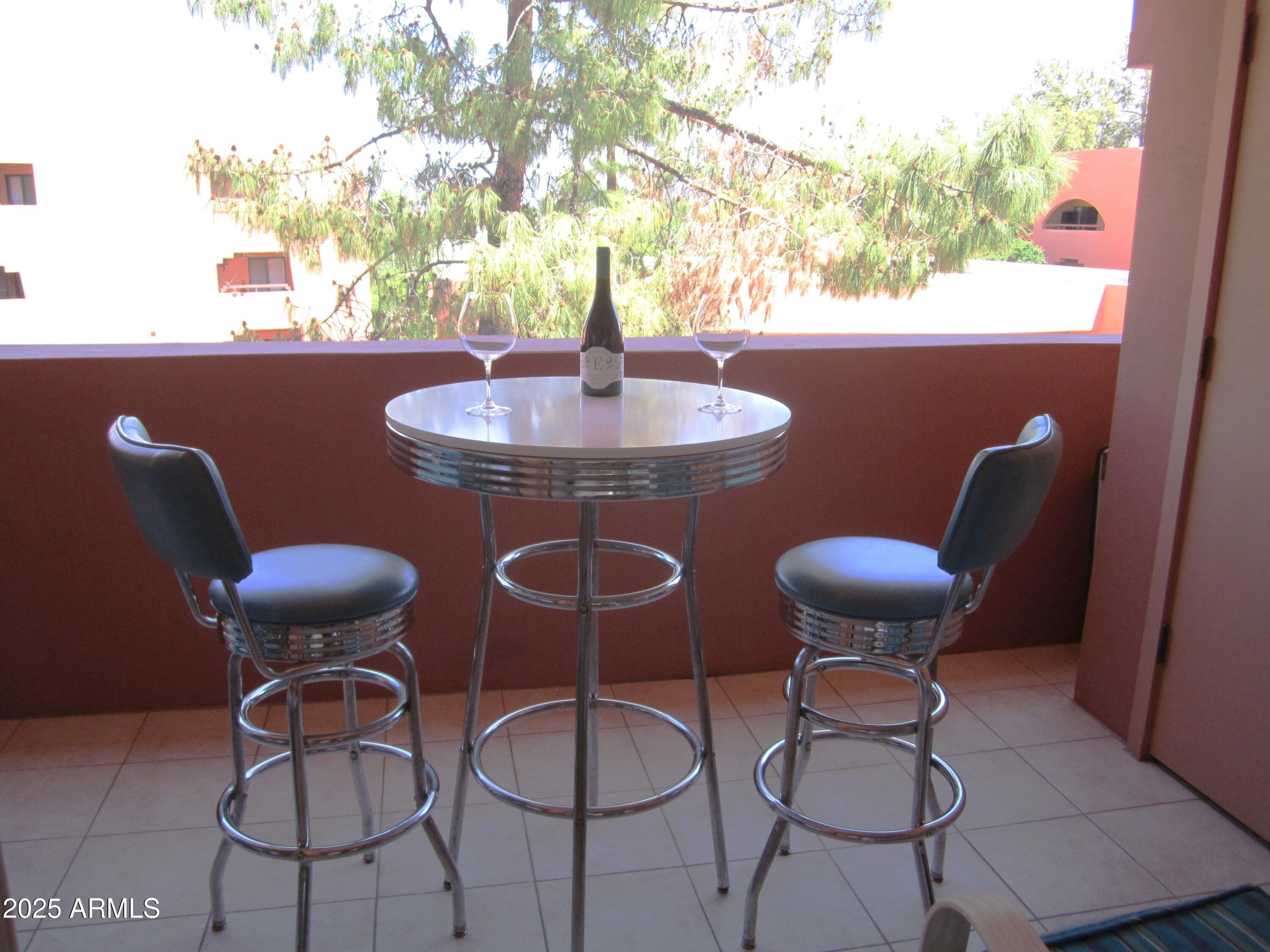4303 East Cactus Road, Unit 413 Phoenix, AZ 85032 - Photo 6 of 30 a table and chairs in a patio