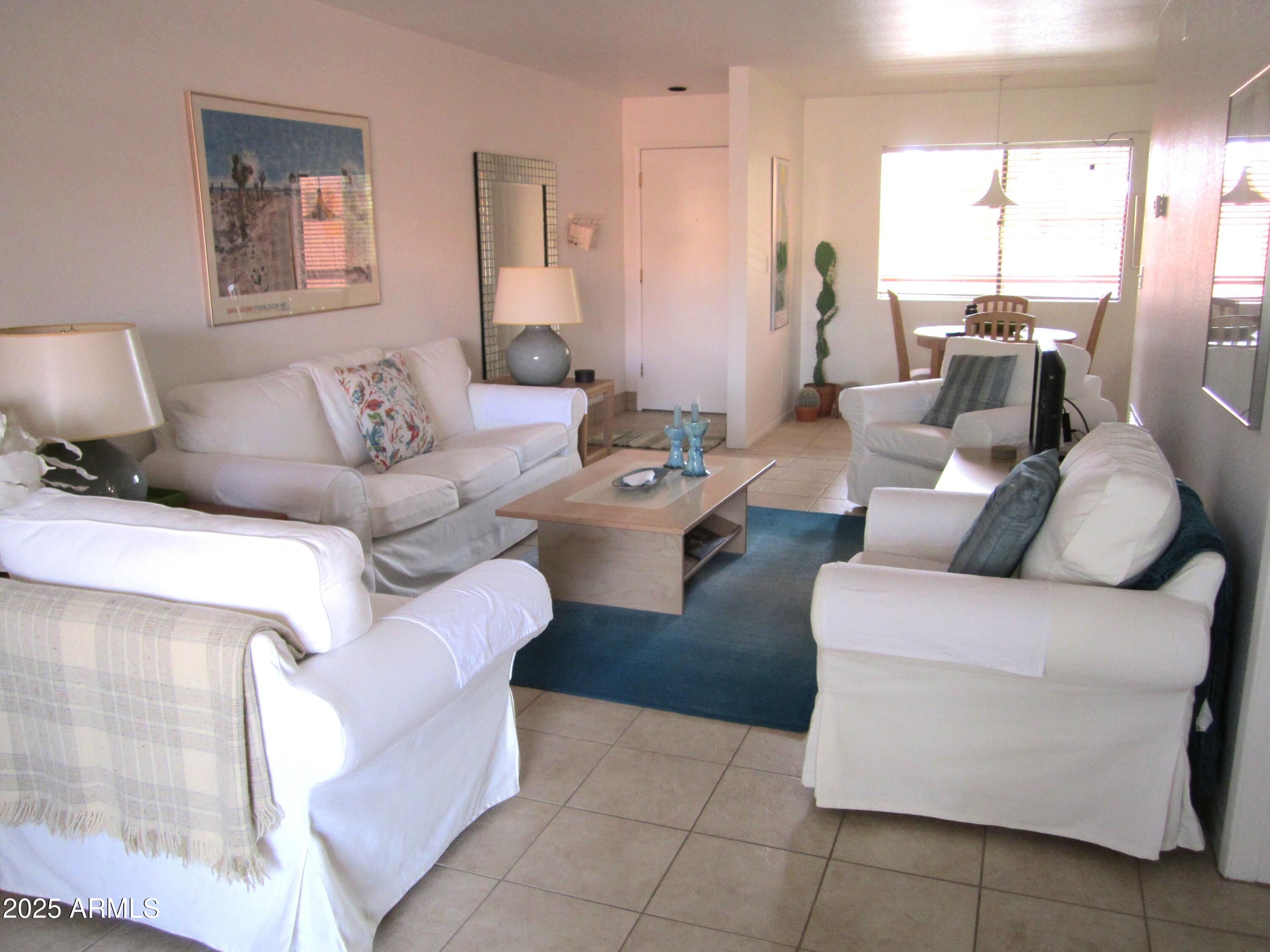 4303 East Cactus Road, Unit 413 Phoenix, AZ 85032 - Photo 7 of 30 a living room with furniture and a large window