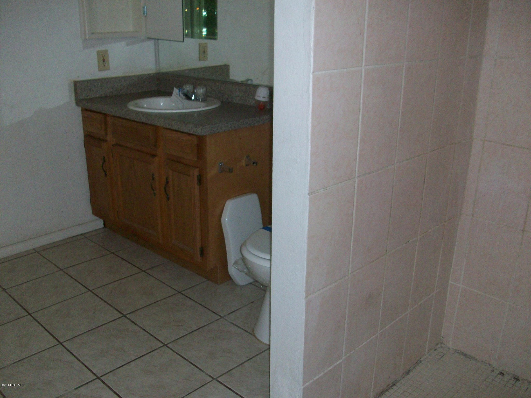 1161 Hodges Circle Rio Rico, AZ 85648 - Photo 20 of 23 a bathroom with a granite countertop sink and a mirror